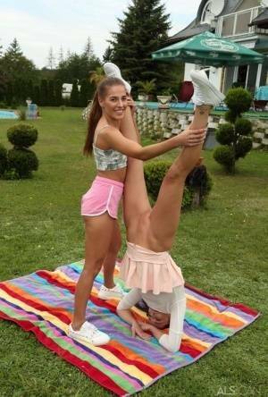 Young lesbians Eveline Dellai & Katy Rose fist pussies during sex on a lawn on tubephoto.pics