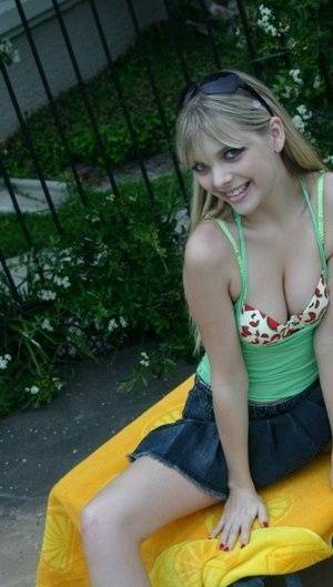 Young blonde Jana Jordan exposes her pretty bra and panties by a swimming pool - Jordan on tubephoto.pics