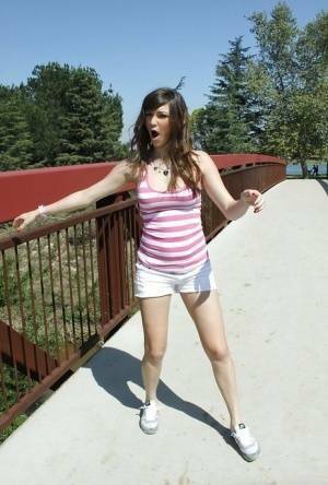 Flexible babe in shorts Holly Michaels shows her sports body outdoor on tubephoto.pics
