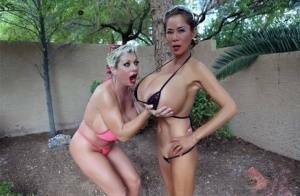 Big titted older women Claudia Marie and Minka kiss outdoors in skimpy bikinis on tubephoto.pics