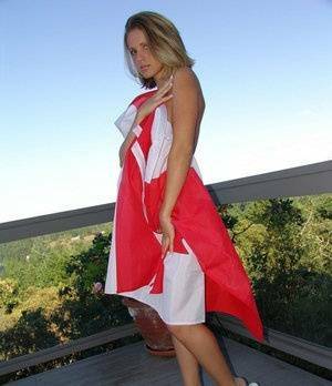 Canadian teen Karen wraps her naked body in a flag on her back deck on tubephoto.pics