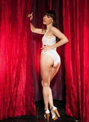 Leggy brunette Dana Dearmond sets her boobs free from bodysuit in heels on tubephoto.pics