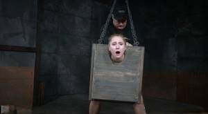 Blonde girl Odette Delacroix is made to suck a black cock with head in stocks on tubephoto.pics