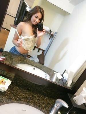 Sassy brunette stripping in front of the mirror and making selfies on tubephoto.pics