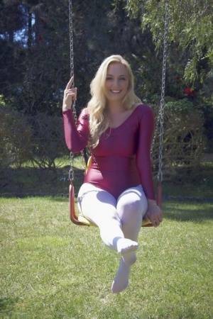 Busty blonde Hayley Marie Coppin strips bodysuit and white pantyhose outdoors on tubephoto.pics