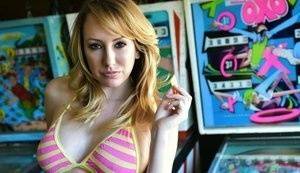 Brett Rossi fingers her pussy in striped OTK socks atop pinball machine on tubephoto.pics