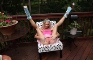 Thin blonde Sky Pierce attaches clamps to her wide open pussy on a deck on tubephoto.pics