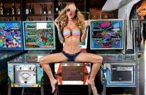 Inked chick Sarah Jessie toys her pussy atop a pinball machine while alone on tubephoto.pics