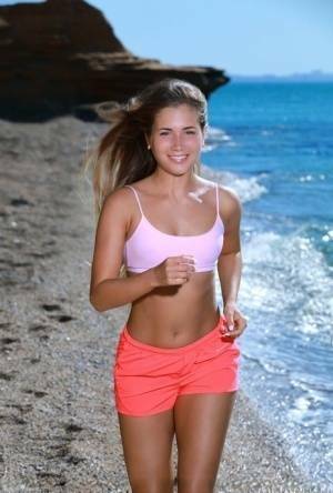 Fit young girl Mary Rock gets completely naked on a beach after exercising on tubephoto.pics