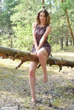 Nice young girl Ari gets completely naked while in a forested area on tubephoto.pics